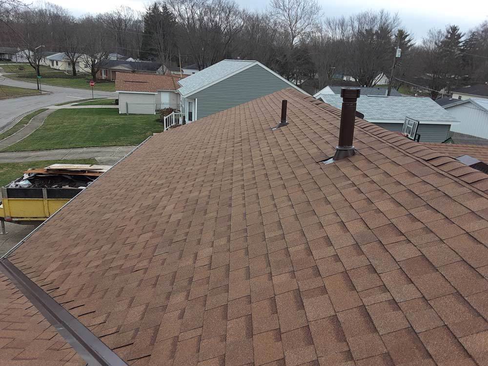 A brown roof with a chimney on top of it.