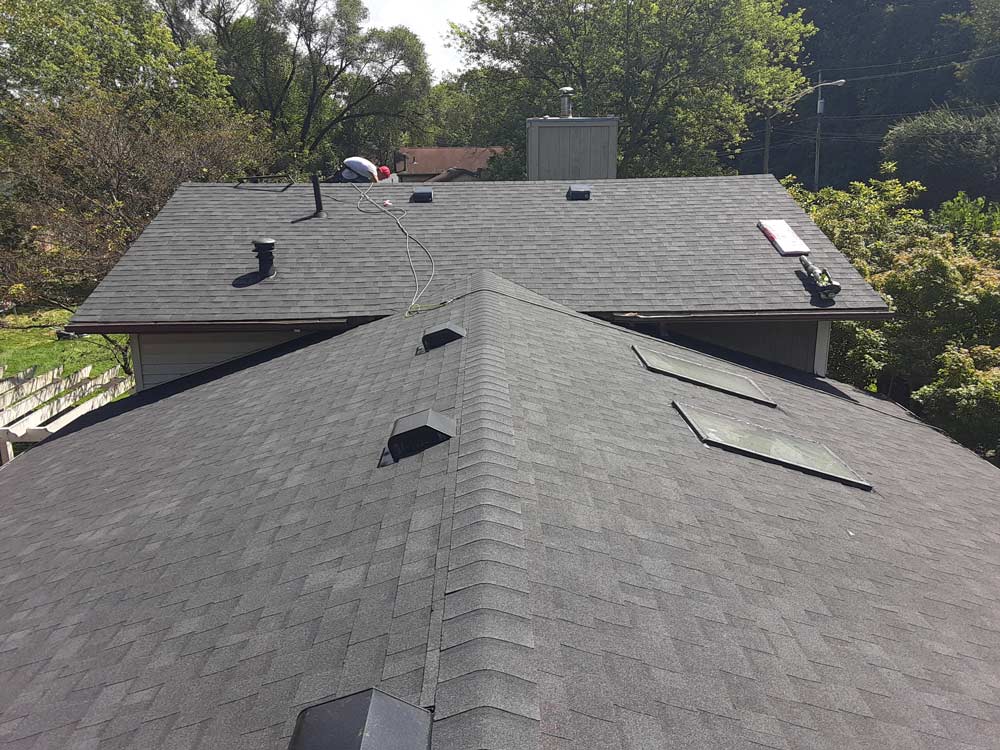 A roof that has been repaired with asphalt shingles.