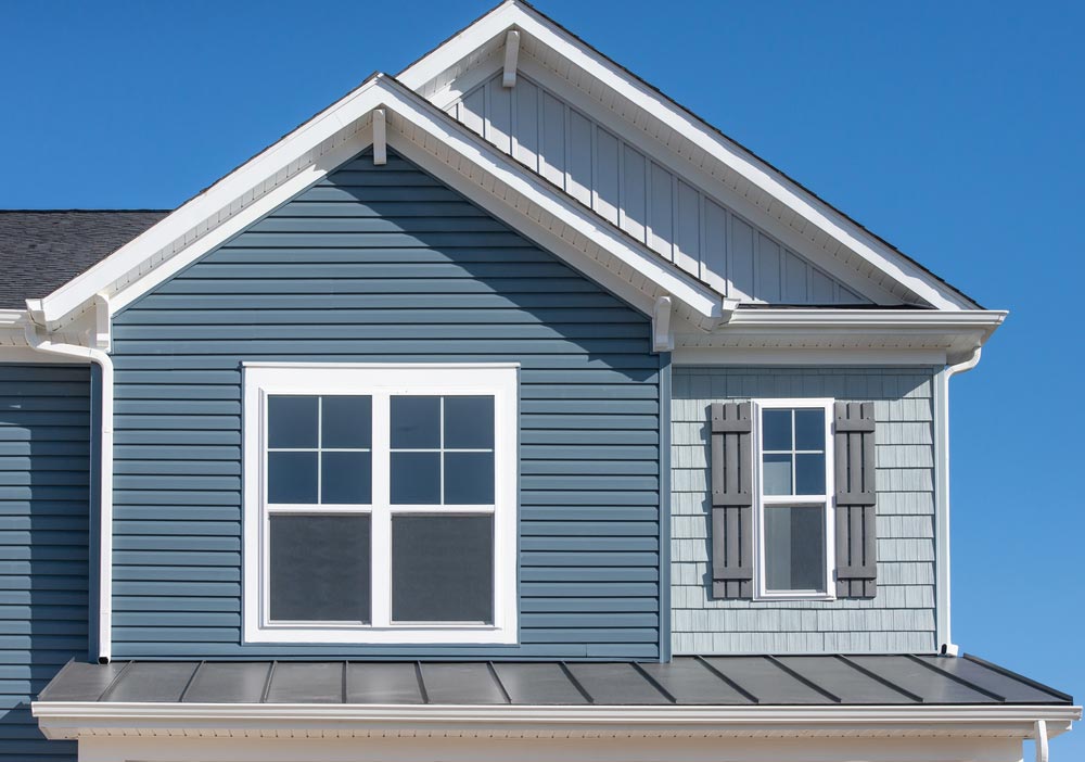 A blue house with white trim and shutters.